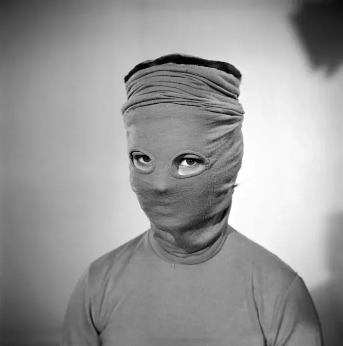Framed Print : Model Mary Dixon wearing a hat that can be converted into a face mask. April 1956