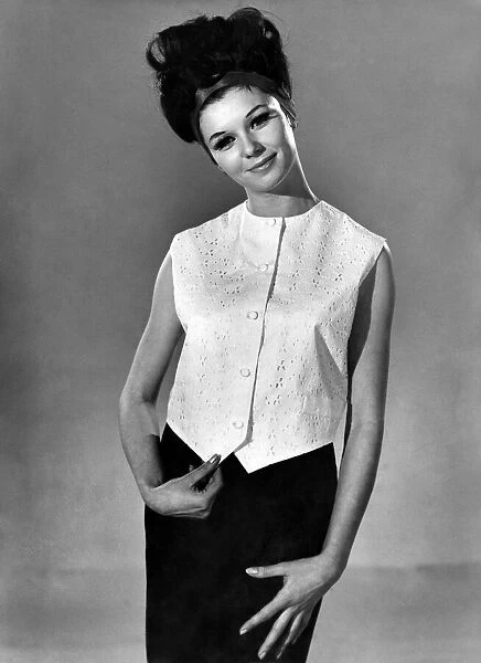 Model Merriel Weston wearing a sleveless blouse top and black skirt