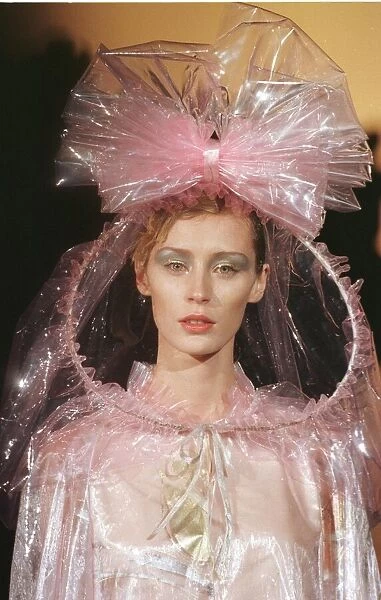 Top model pink plastic dress under a pink plastic cape designed by Paco Rabanne for his