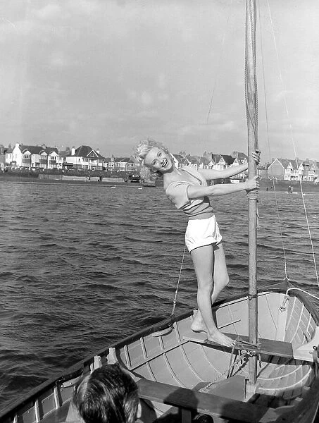 A model poses on a boat at Hove March 1959