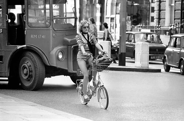 Model riding a bicycle in Kings Road Chelsea, London. April 1975 75-2156-009
