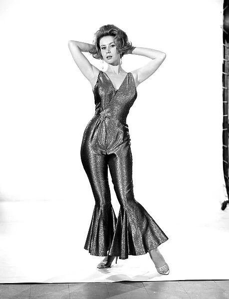 Model Rita Royce wearing lurex suit. Circa 1963