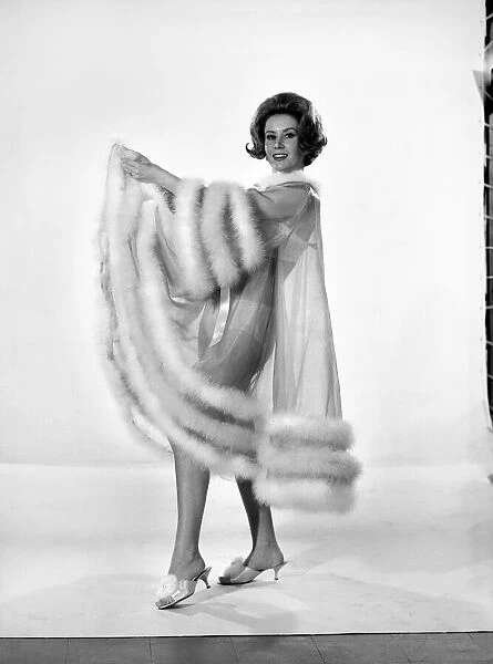 Model Rita Royce wearing marabou fur trimmed nightie. December 1963