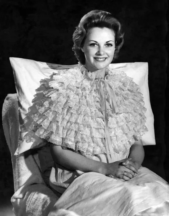 Framed Print : Model Roma Reeves wearing an unusla style nightie sitting up in bed