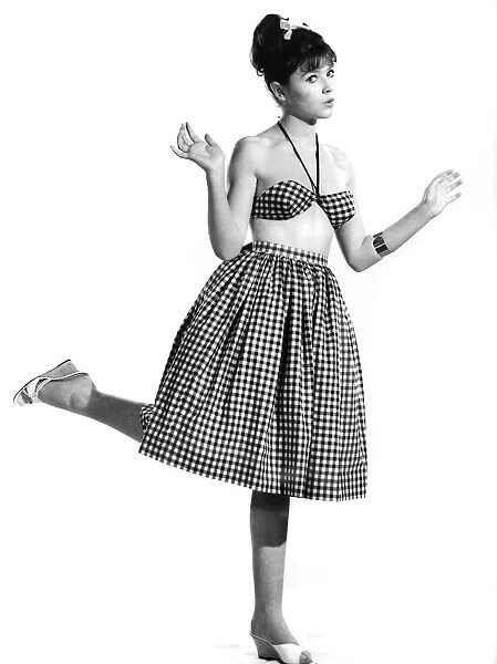 Model Rosemary Bell wearing a checkered skirt and matching top