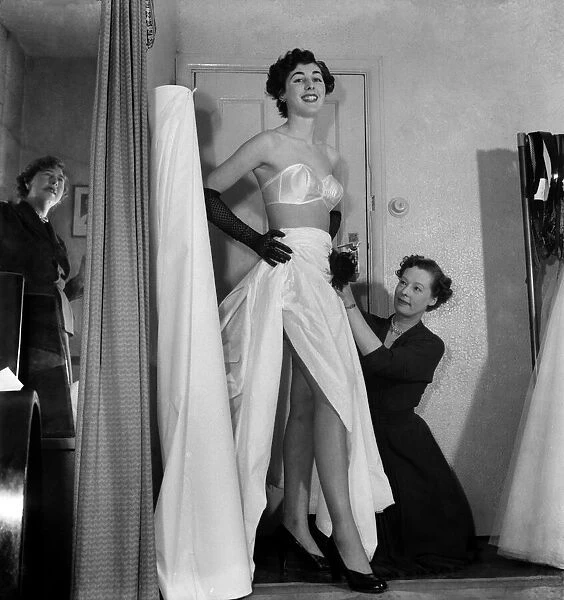 Model Shirley Galley, 'Miss Velvet'seen here having her dress fitted by