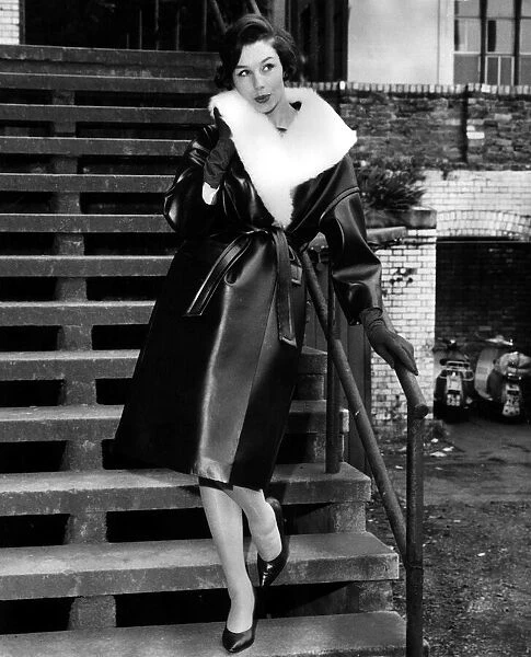 Model Stella Grove August 1960 in a leather look outfit lined with fur standing