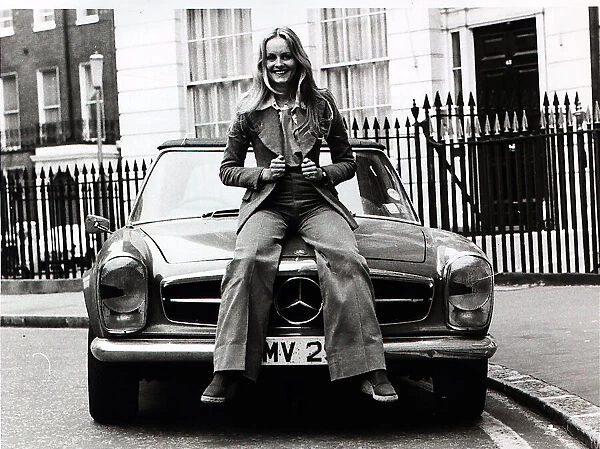 Model, Twiggy, pictured in London sitting on the bonnet of her Mercedes sports car