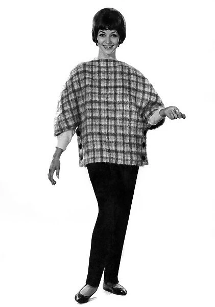 Model Valerie Gaten wearing patterned top with trousers. October 1961 P008804