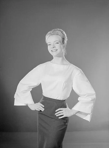 Model Valerie Hollman wearing white blouse and dark skirt