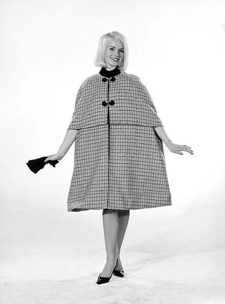 Model Vyvyan Dunbar wearing check cape which can be worn either full length or quarter