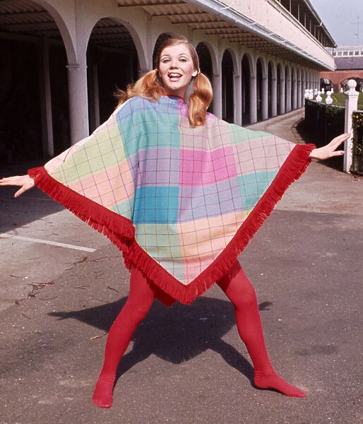 Model wearing a fringed poncho design by J P Fashion with red stockings