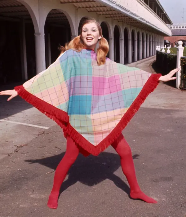 Framed Print : Model wearing a fringed poncho design by J P Fashion with red stockings