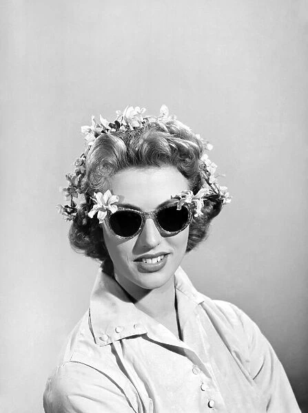 Model wearing glasses decorated with flowers. 1955