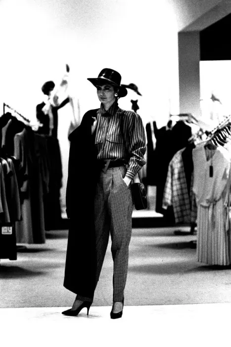 Framed Print : A model wearing some high waisted trousers with a blouse, hat and coat in March 1987 Framed Print : A model wearing some high waisted trousers with a blouse, hat and coat in March 1987