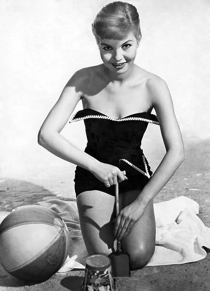 Model wearing a one piece swimsuit. May 1957 P018062