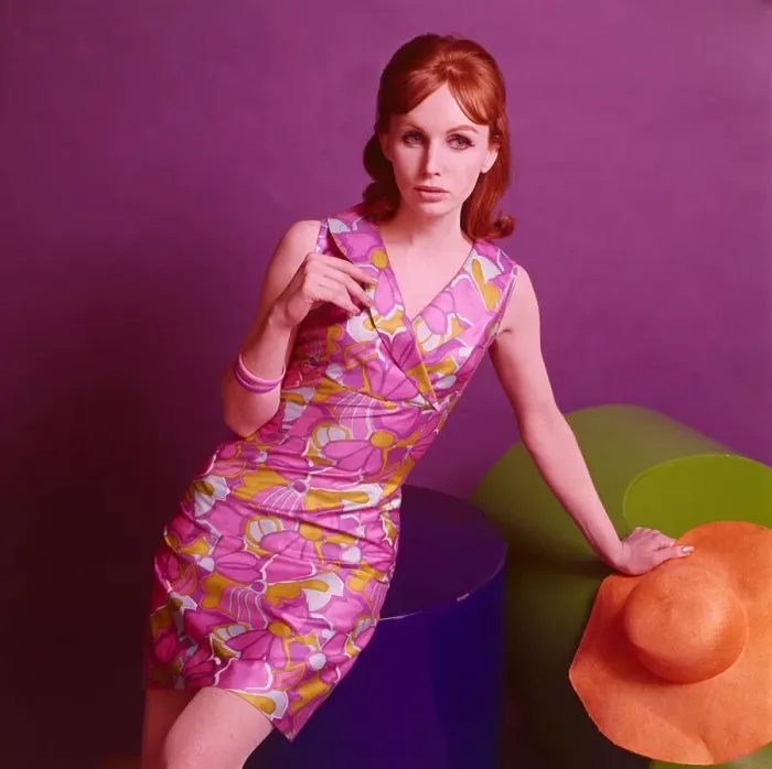 Framed Print : Model wearing a satinised cotton dress with a purple floral pattern, May 1967 Framed Print : Model wearing a satinised cotton dress with a purple floral pattern, May 1967