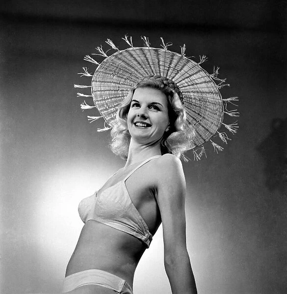 Model wearing straw hats. April 1953 D1688-004