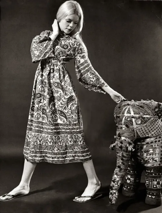 Framed Print : A model wearing a swirly print midi dress with wide bell sleeves made from Indian cotton