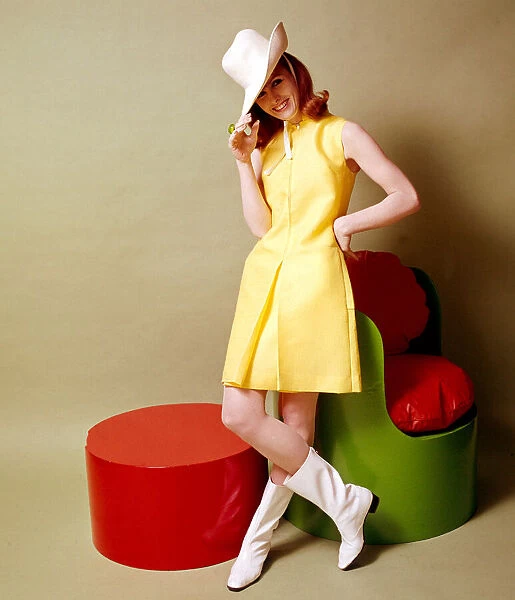 Model wearing a yellow linen look tent style dress with zip front