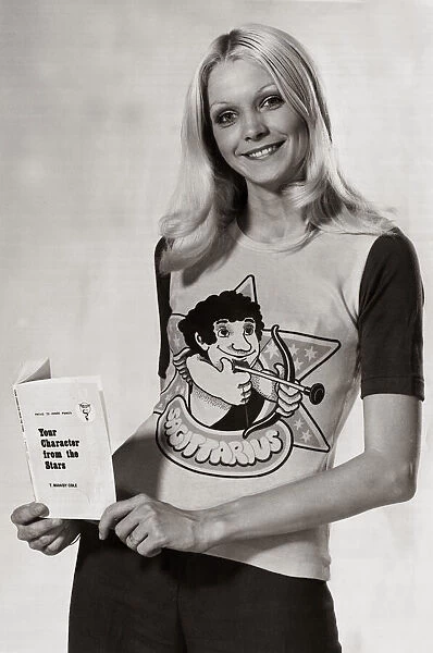 Model wearing a zodiac sign t-shirt witha cartoon of Sagittarius on it holding a book