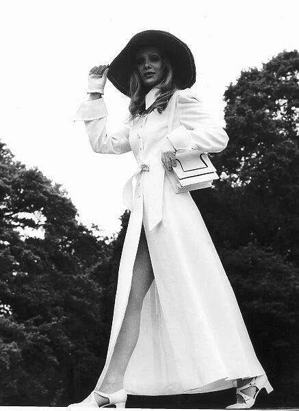 Model wears long white coat at Royal Ascot in June 1969 with floppy hat