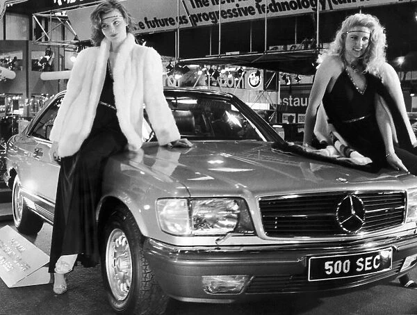 Two models draped over the bonnet of the new Mercedes 500 Sec at the 1982 Motor Show
