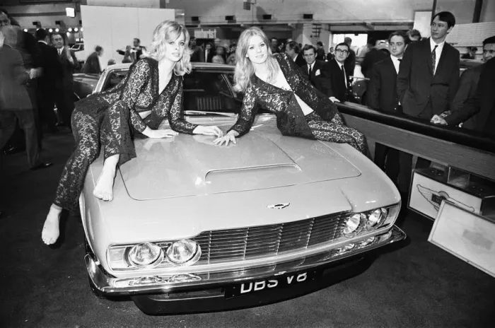 Framed Print : Models drapped over the bonnet of an Aston Martin DBS V8 at the 1969 Motor Show 1st June