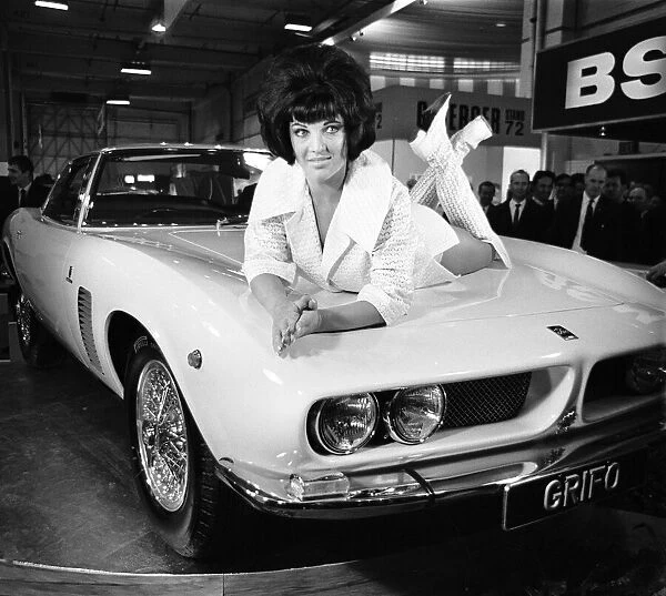 Models drapped over the latest Iso Grifo car at the 1966 London Motor Show 18th October