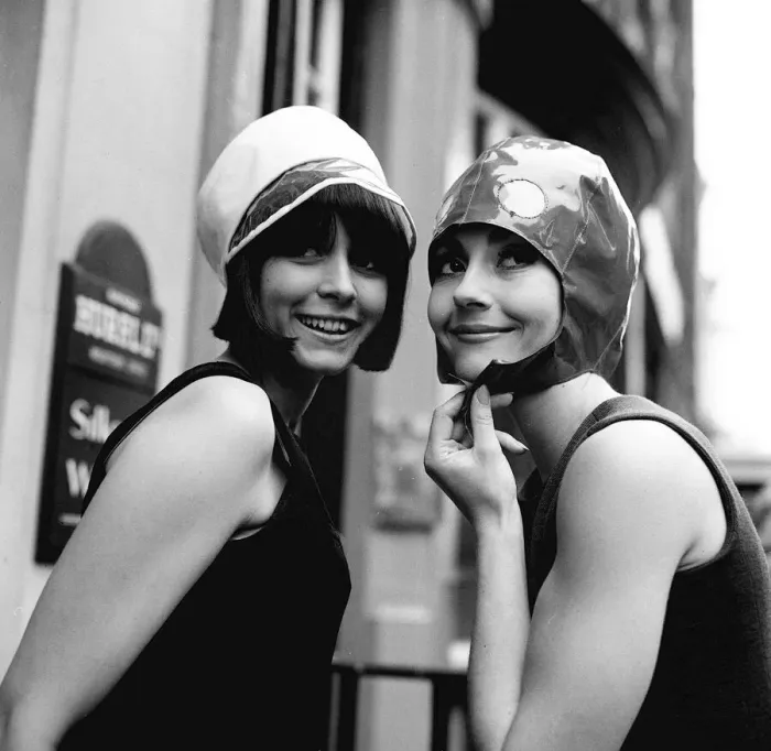 Framed Print : Two models model hats June 1965 One wears a white hat with dark trimming Framed Print : Two models model hats June 1965 One wears a white hat with dark trimming