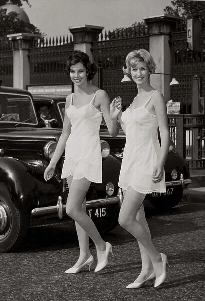 Two models walking by Hyde park corner wearing their slips after slipping out from a