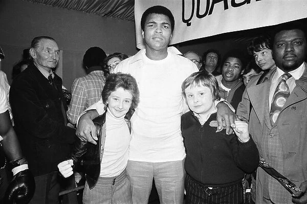 Mohammed Ali seen here with two young fight fans at Quaglinos Restaurant