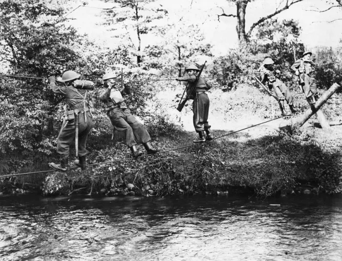 Framed Print : Monmouthshire Home Guard negotisting a river by means of a slender wire bridge of their Framed Print : Monmouthshire Home Guard negotisting a river by means of a slender wire bridge of their