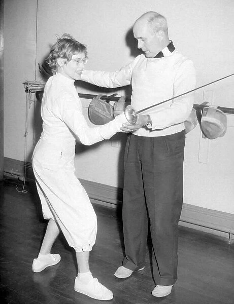 Monsieur Henri Faubert, fencing instructor, gives a valuable tip to librarian Shirley