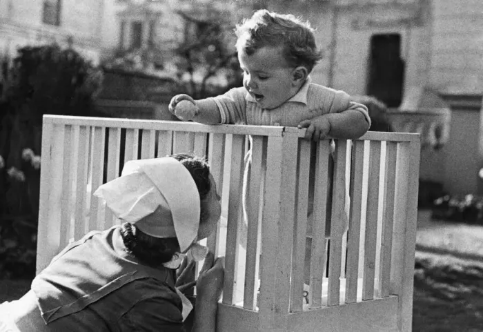 Framed Print : An eleven month old baby boy plays in his cot at the London nursing home where he was Framed Print : An eleven month old baby boy plays in his cot at the London nursing home where he was