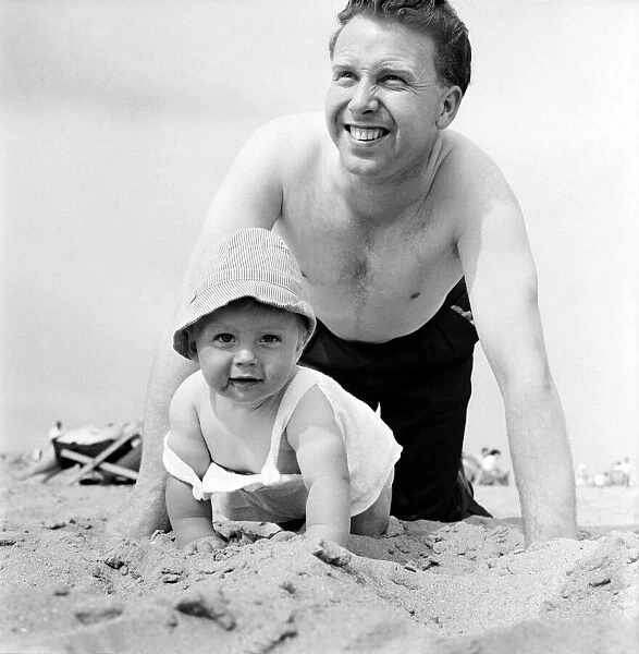 Nine month old Paul Kemshell crawling on the sands at Rhyl with his daddy Mr