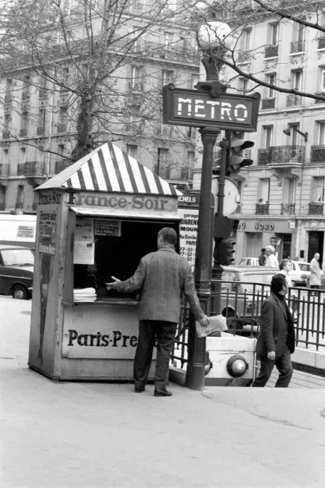 Framed Print : A Morning newspaper reader picks up his paper from a kiosk in the 15th district of Paris
