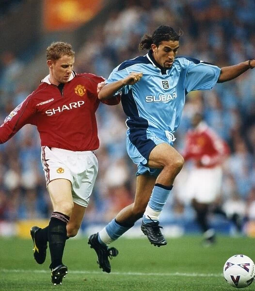 Moroccan-born Sky Blues player Moustapha Hadji and Manchester Uniteds Nicky Butt