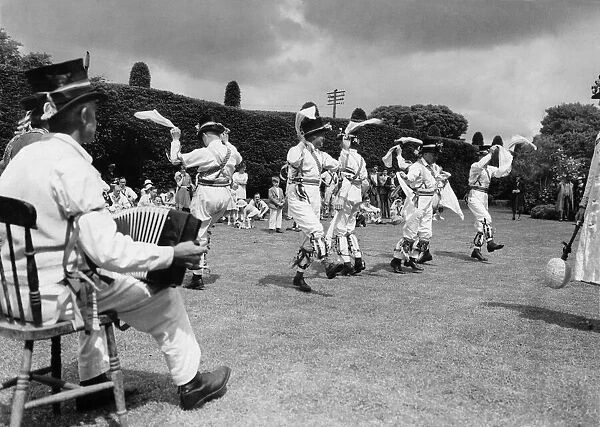Morris dancers at Thaxted in Essex perform on the village green. June 1939 P029097