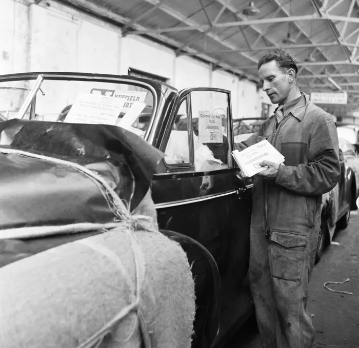 Framed Print : Morris Minor Low Light Sedans fresh of the production line after being packed for Framed Print : Morris Minor Low Light Sedans fresh of the production line after being packed for