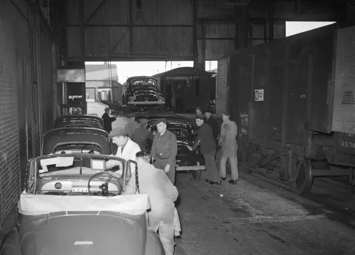 Framed Print : Morris Minor Low-Light Sedans fresh of the production line packed for export Framed Print : Morris Minor Low-Light Sedans fresh of the production line packed for export