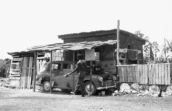 A Morris Oxford undergoing repairs at a auto repair garage off the Spanish Town Road