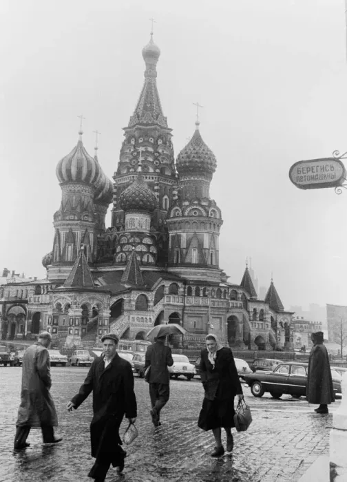 Framed Print : Moscovites with their heads down against the rain seen here passing St Basil Framed Print : Moscovites with their heads down against the rain seen here passing St Basil