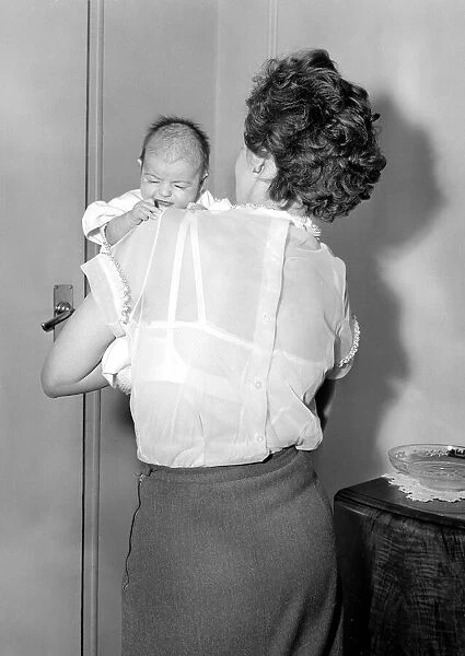 A mother holding her newly born baby in her arms Circa 1954