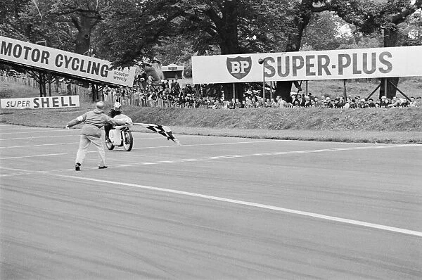 Motor Cycle Racing at oulton Park. Phil read takes the chequered flag after winning