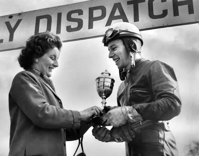 Framed Print : Motor cycle racing. Oulton Park Spring Meeting. Mrs. Geoff Duke presents a triumphant Framed Print : Motor cycle racing. Oulton Park Spring Meeting. Mrs. Geoff Duke presents a triumphant
