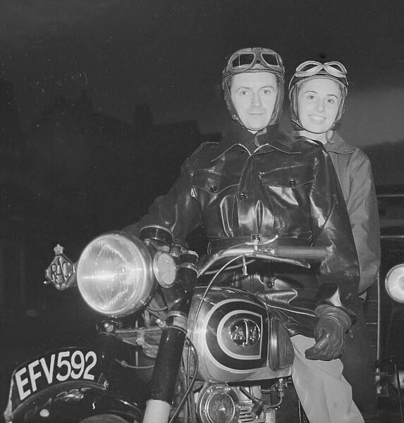 Motor cyclist and pillion passenger Mrs and mrs Tom Mason seen here on their AJS