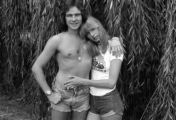 Motorcycle champion Barry Sheene at home with 1976 girlfriend Stephanie McLean in garden