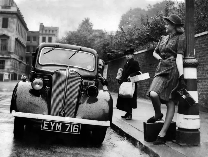 Framed Print : Motorist seen here offer a young woman a lift as he ignores the elderly woman with Framed Print : Motorist seen here offer a young woman a lift as he ignores the elderly woman with