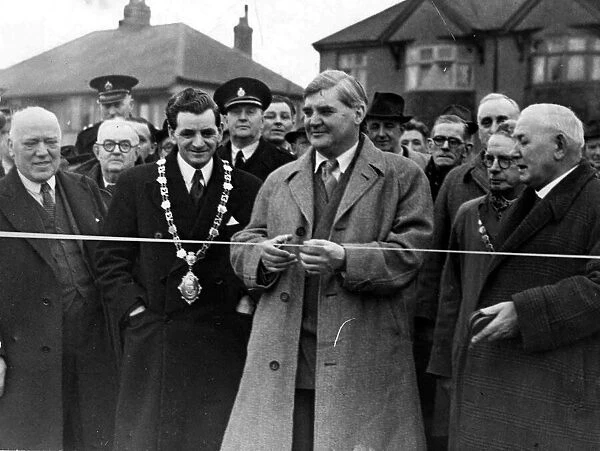 Mr Aneurin Bevin, M. P. about to cut the tape across Bevin Crescent